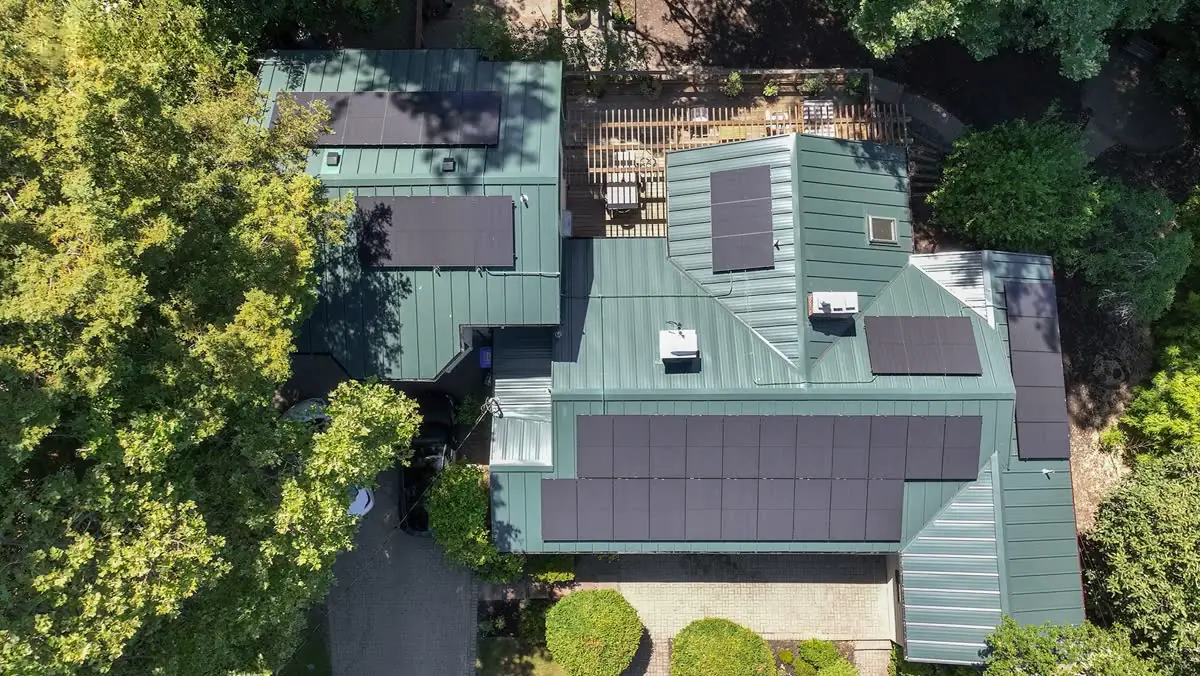 Aerial view of standing-seam metal roof with integrated solar panels